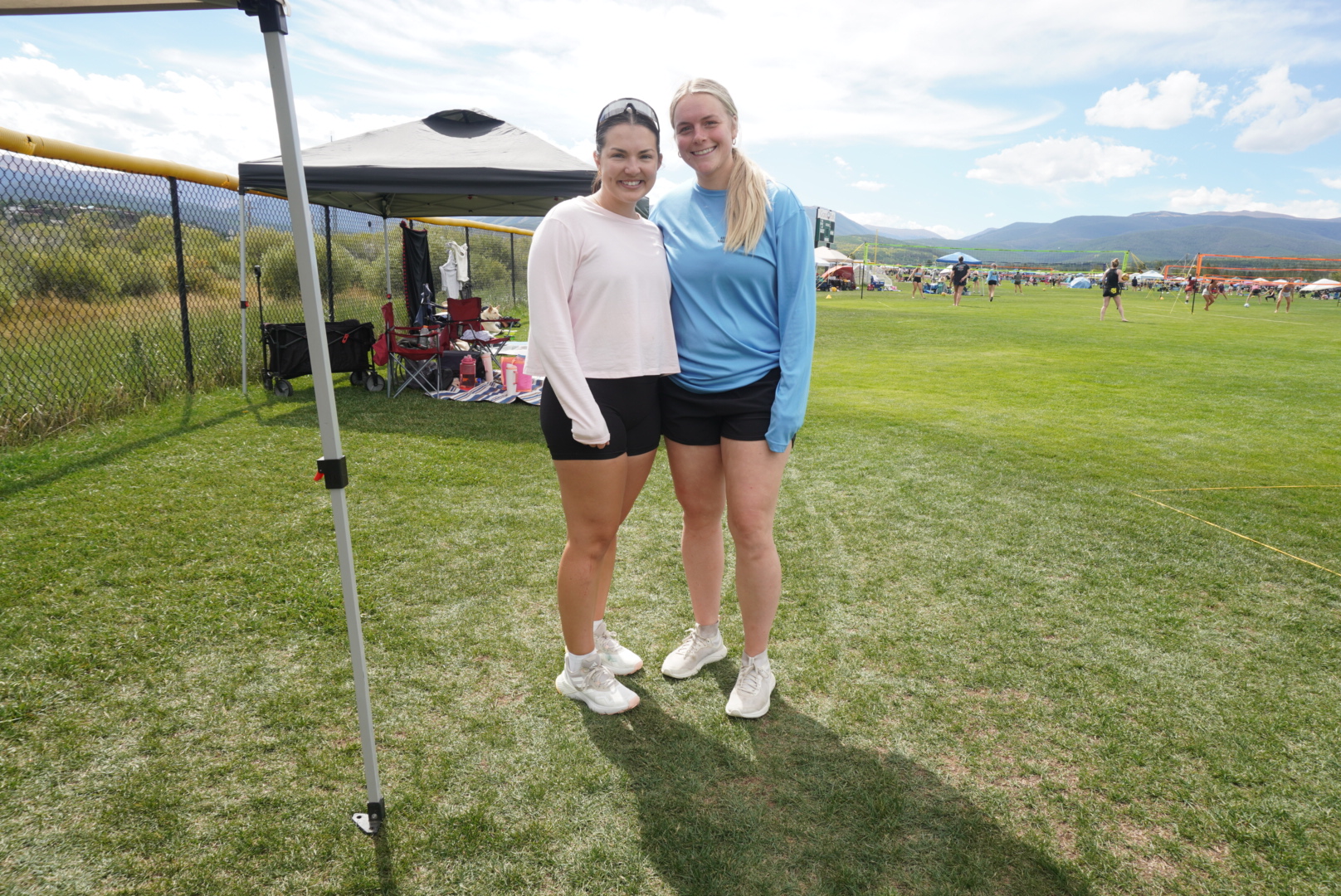 Two members of the VC Denver team at an outdoor volleyball event